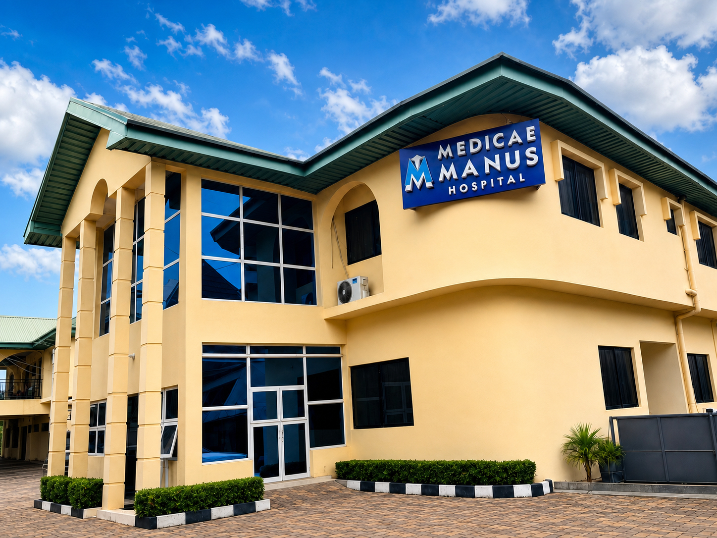 Exterior view of Medicae Manus Hospital with the hospital sign above the entrance